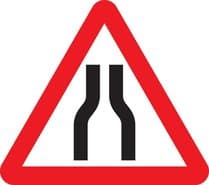 Road narrows on both sides
